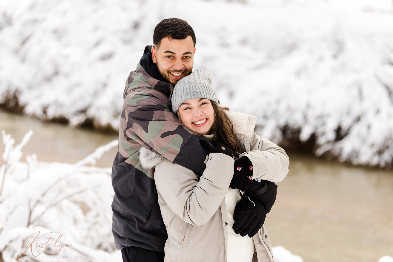 Couple pose during a winter engagement photo session.