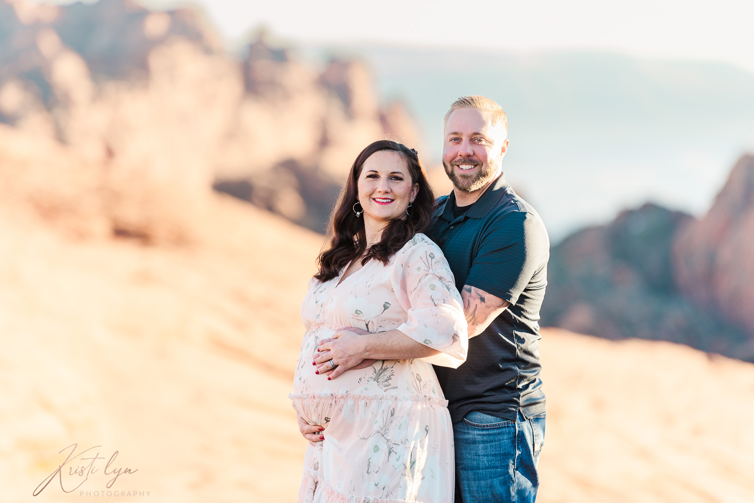 Expectant couple posing during maternity session.