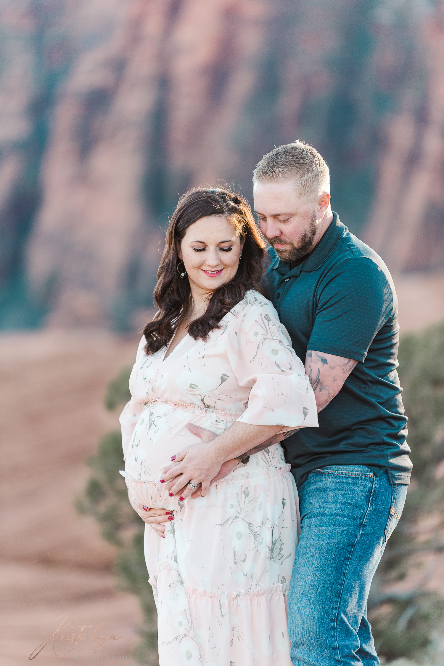 Parents pose during their maternity session in Snow Canyon State Park